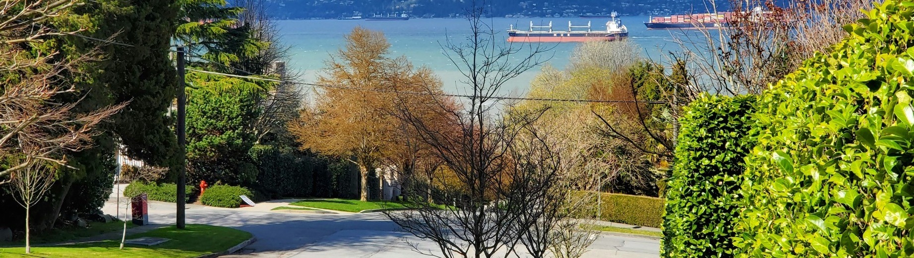Local residential street in North Vancouver overlooking the ocean and mountains