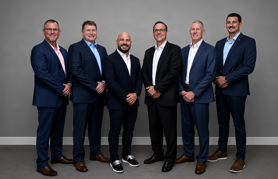 five men in business professional attire in front of white background