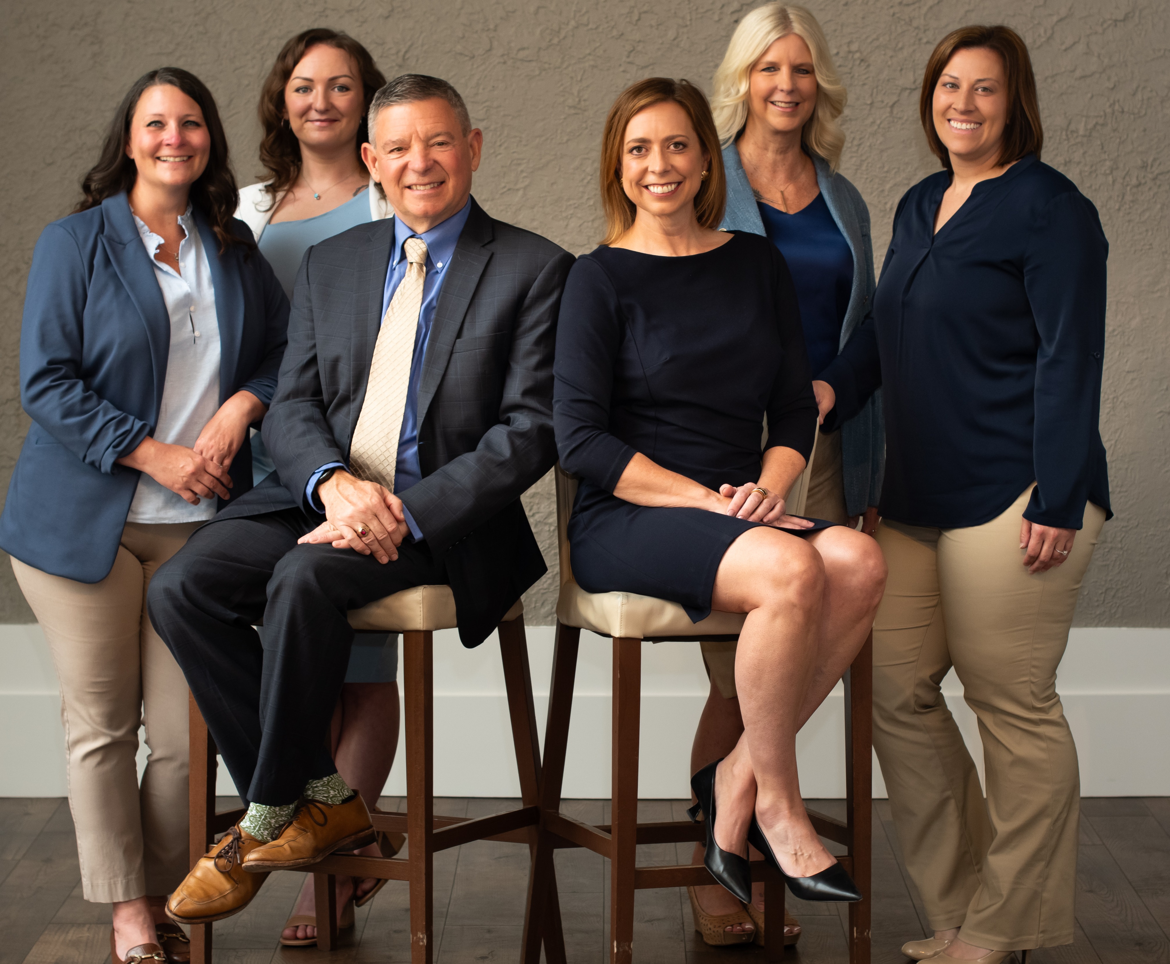 Employees of Shoreline Group posing for a photo wearing red and black professional clothing