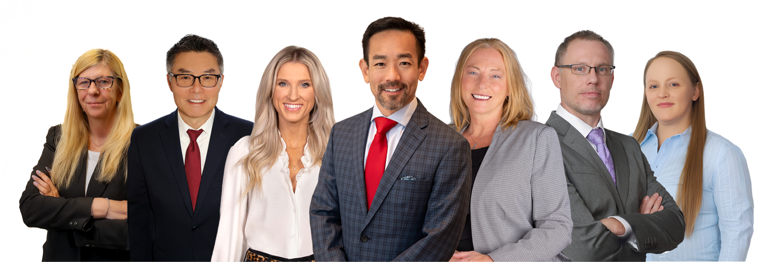 Three men and four women in professional clothing, smiling at the camera