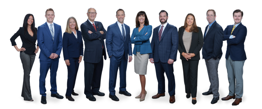 Four men and three women in black business suits standing in front of wood paneling with Thrivent logo